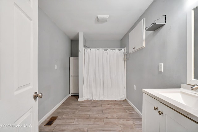 286 State Hwy Unit 80, Fort Plain, NY 13339 - bathroom with curtained shower, baseboards, vanity, and wood finished floors