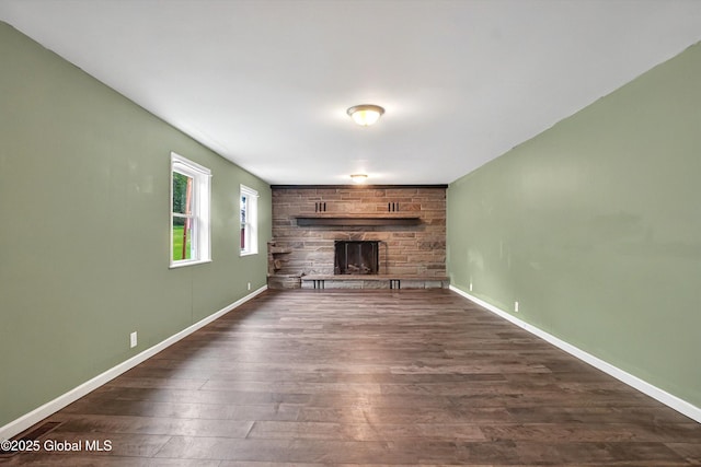 286 State Hwy Unit 80, Fort Plain, NY 13339 - unfurnished living room with a fireplace, dark wood-type flooring, and baseboards