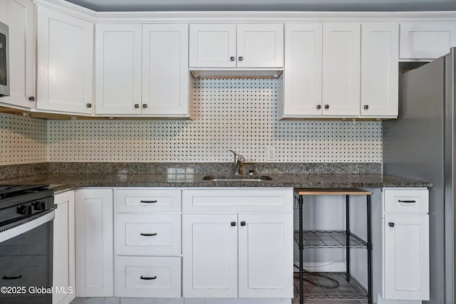 286 State Hwy Unit 80, Fort Plain, NY 13339 - kitchen featuring a sink, appliances with stainless steel finishes, white cabinetry, and dark stone countertops