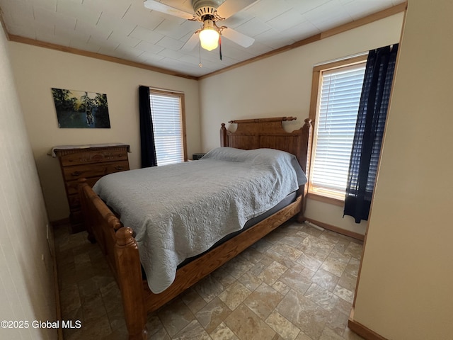 bedroom featuring baseboards, stone finish flooring, ceiling fan, and crown molding