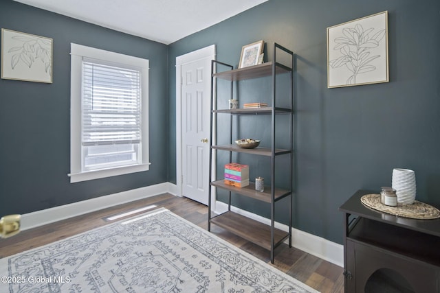 interior space with baseboards and wood finished floors