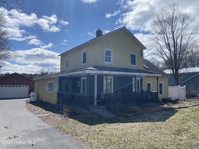 470 Middle Grove Rd, Greenfield, NY 12850 - view of front of home with an outbuilding, a detached garage, a chimney, covered porch, and a front yard