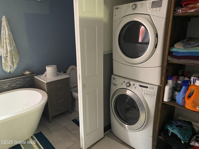 470 Middle Grove Rd, Greenfield, NY 12850 - clothes washing area with stacked washer / dryer and light tile patterned floors