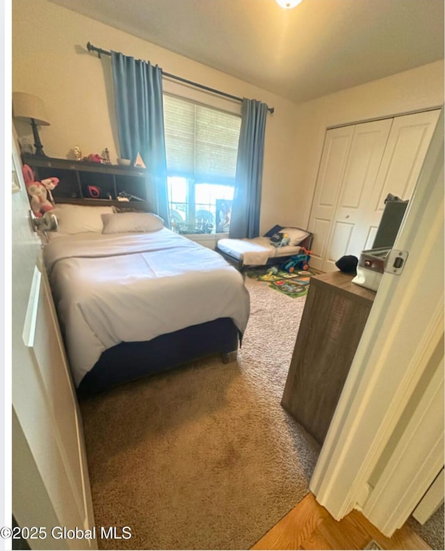 carpeted bedroom featuring a closet