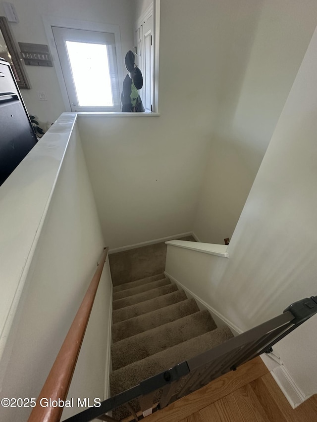 stairway featuring baseboards