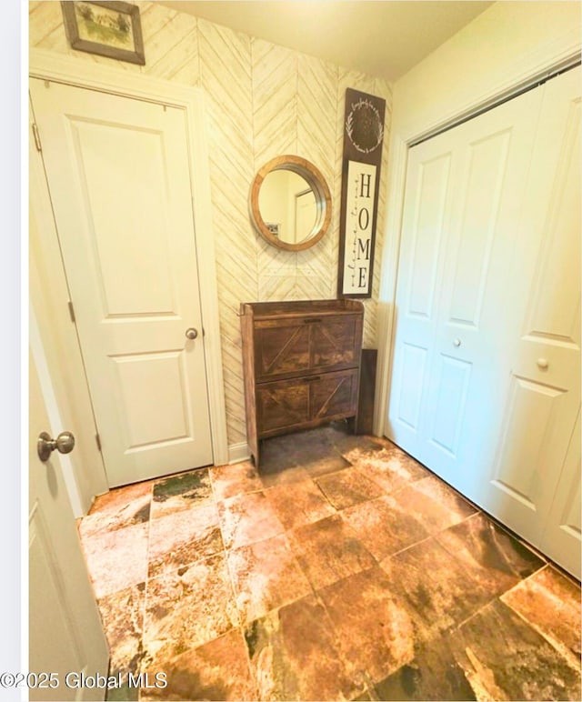 hallway featuring wallpapered walls