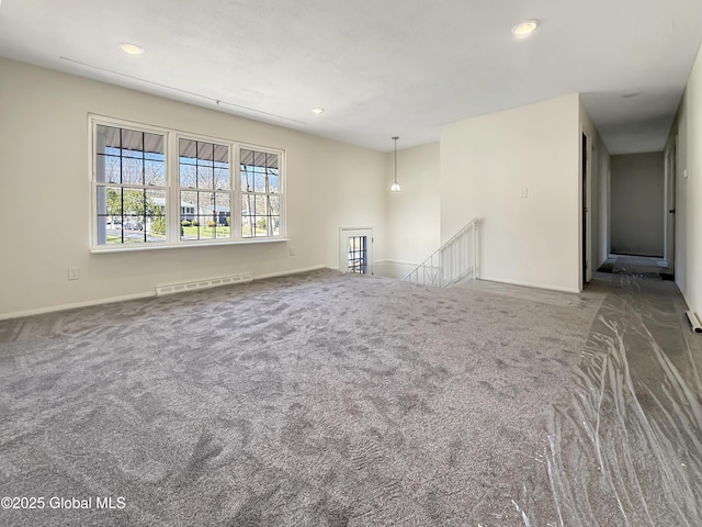 unfurnished living room featuring carpet floors, recessed lighting, baseboards, and visible vents