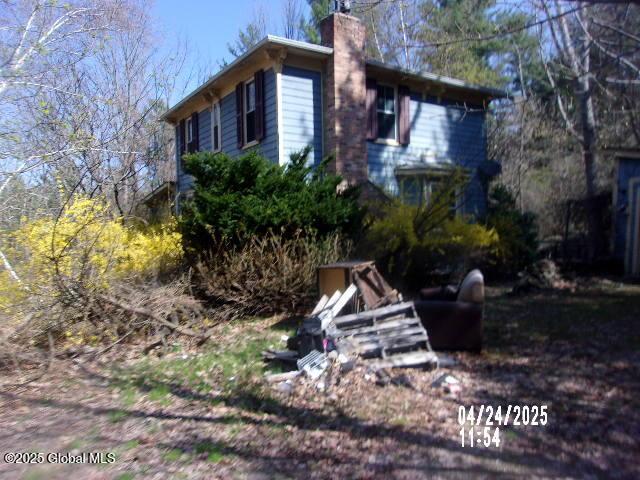 view of side of home featuring a chimney