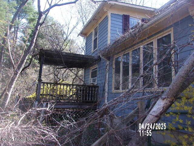view of side of property with a wooden deck