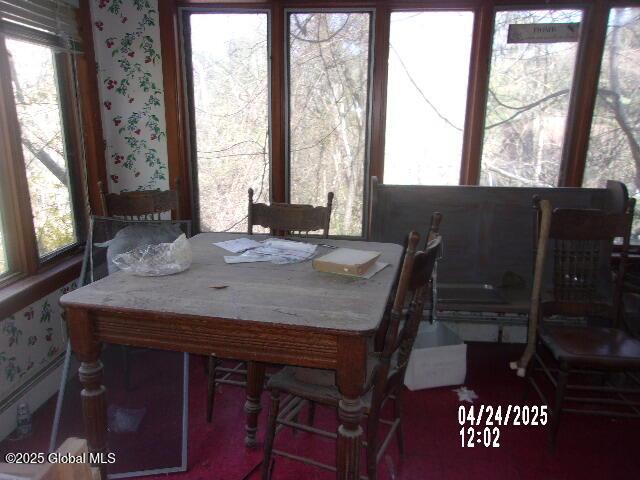 dining area featuring wallpapered walls