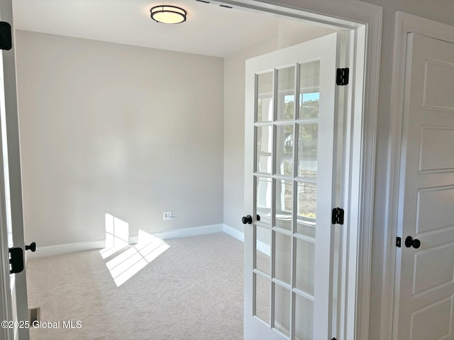doorway to outside featuring baseboards, carpet, and a wealth of natural light