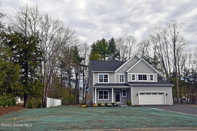 view of front of house with a garage, fence, a front lawn, and aphalt driveway