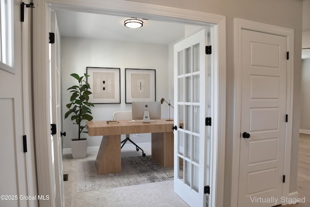 home office featuring baseboards and carpet