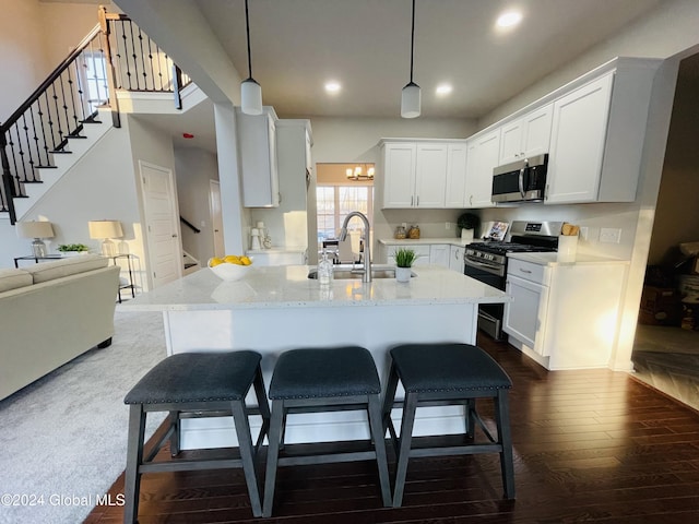 10 Hunter Ct, Milton, NY 12020 - kitchen with light stone countertops, a sink, dark wood-style flooring, white cabinets, and appliances with stainless steel finishes
