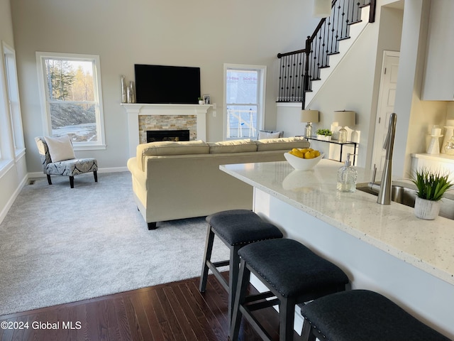 10 Hunter Ct, Milton, NY 12020 - living room featuring dark wood finished floors, stairway, a fireplace, and plenty of natural light