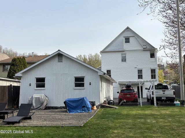 back of house featuring fence and a yard