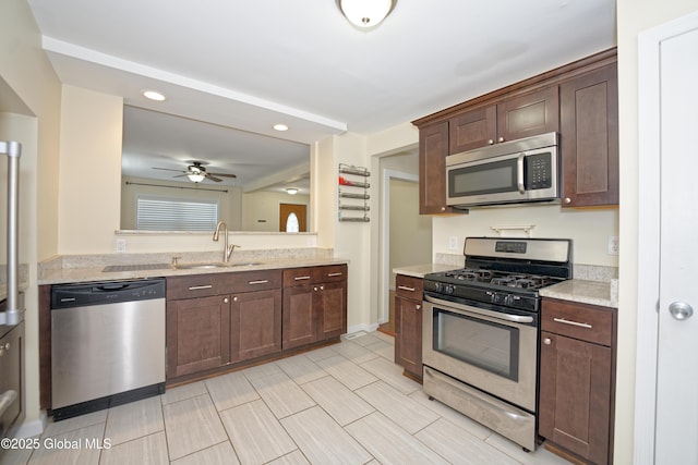 kitchen with recessed lighting, dark brown cabinets, a sink, appliances with stainless steel finishes, and ceiling fan