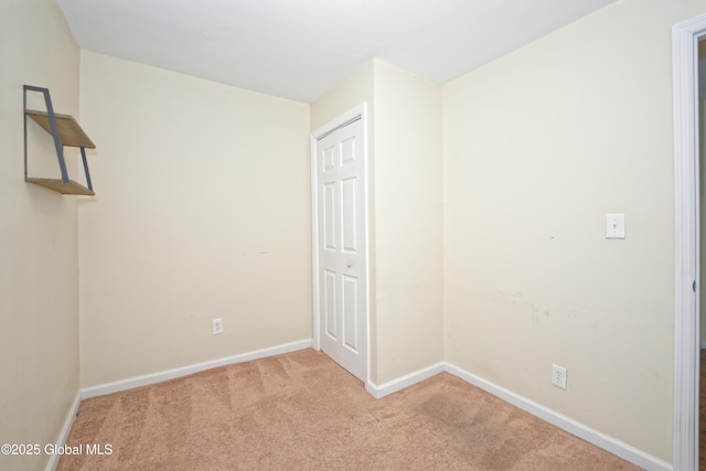 carpeted spare room with baseboards