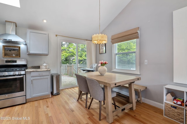 21 St Charles Pl, Saratoga Springs, NY 12866 - dining room with plenty of natural light, light wood-type flooring, vaulted ceiling, a chandelier, and baseboards