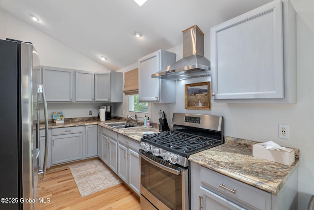 21 St Charles Pl, Saratoga Springs, NY 12866 - kitchen with appliances with stainless steel finishes, wall chimney range hood, a sink, light wood finished floors, and vaulted ceiling