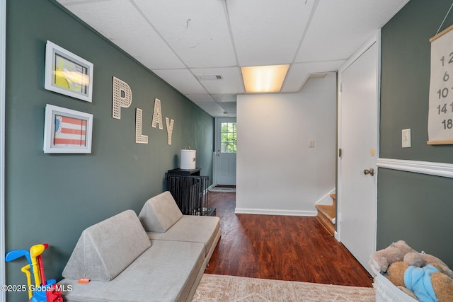 21 St Charles Pl, Saratoga Springs, NY 12866 - living area featuring wood finished floors, a paneled ceiling, stairs, and baseboards
