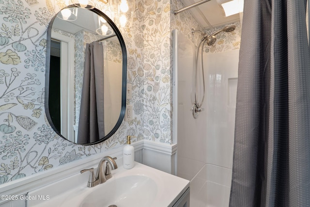 21 St Charles Pl, Saratoga Springs, NY 12866 - bathroom featuring wallpapered walls, vanity, and a wainscoted wall