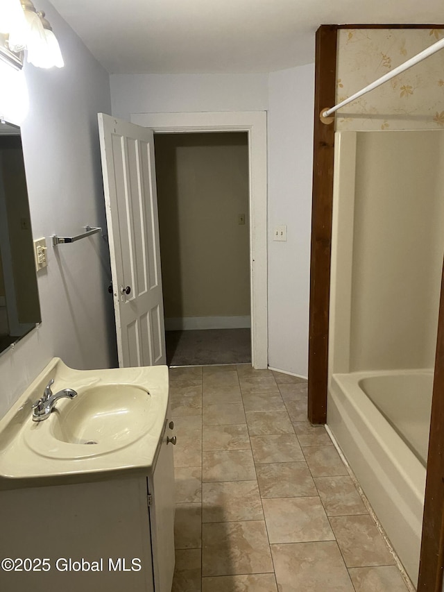 full bath with walk in shower, vanity, a washtub, and tile patterned flooring