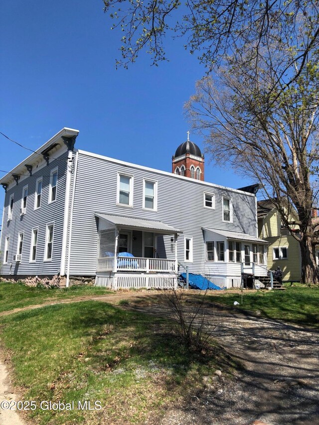 exterior space featuring a porch and a front lawn
