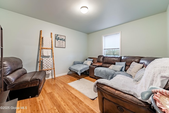 living area featuring baseboards and light wood-type flooring