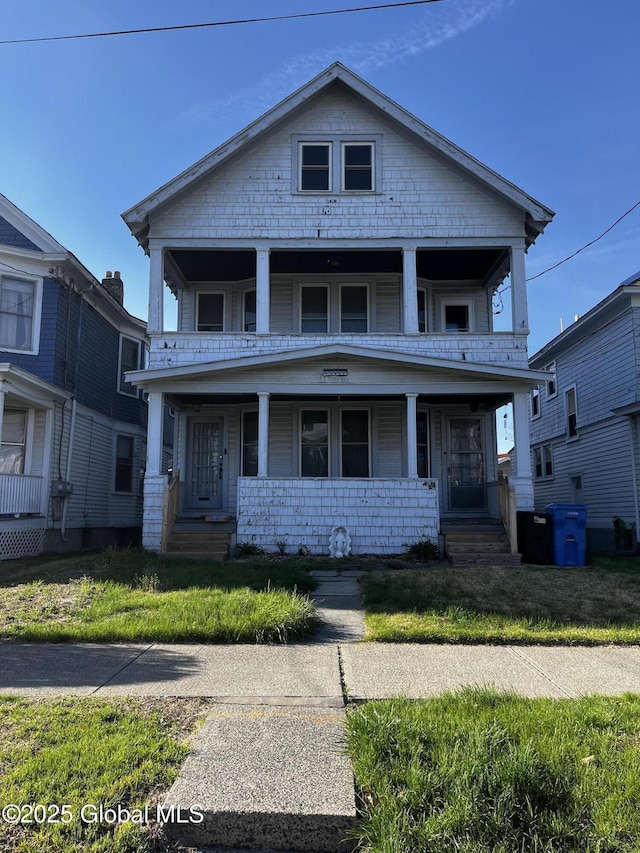 view of front facade featuring covered porch and a balcony