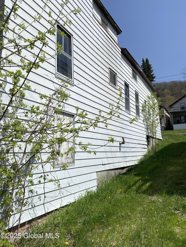 view of property exterior featuring a lawn