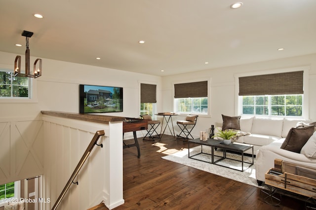 living area featuring dark wood finished floors, recessed lighting, and a chandelier