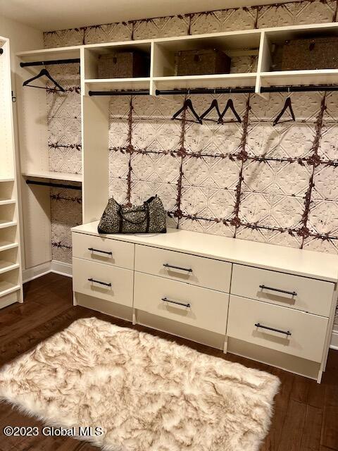 mudroom with dark wood-style floors and baseboards