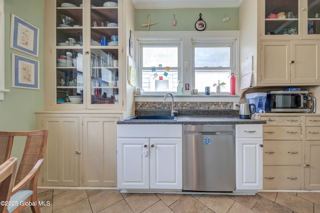 kitchen with a sink, stainless steel appliances, glass insert cabinets, light tile patterned floors, and dark countertops