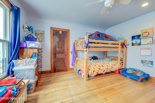 bedroom with wood finished floors, ceiling fan, recessed lighting, and baseboards