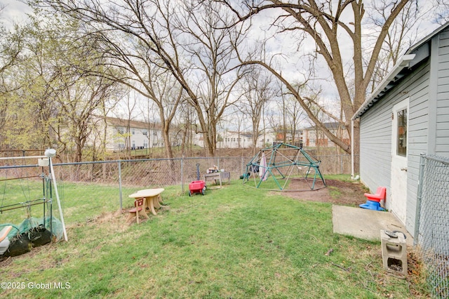 view of yard with a fenced backyard and a playground