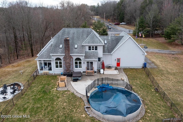 2196 Darrow Rd, Duanesburg, NY 12056 - back of house with a yard, a covered pool, a shingled roof, and a fenced backyard