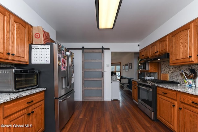 2196 Darrow Rd, Duanesburg, NY 12056 - kitchen featuring dark wood-style floors, a barn door, stainless steel appliances, brown cabinetry, and backsplash