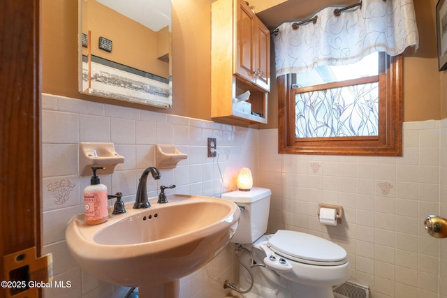 63 Pawling Ave, Mechanicville, NY 12118 - half bathroom featuring tile walls, toilet, and a sink