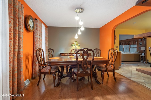 63 Pawling Ave, Mechanicville, NY 12118 - dining space featuring visible vents, light wood finished floors, and arched walkways