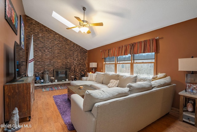 63 Pawling Ave, Mechanicville, NY 12118 - living room with a fireplace, ceiling fan, high vaulted ceiling, and light wood-style floors