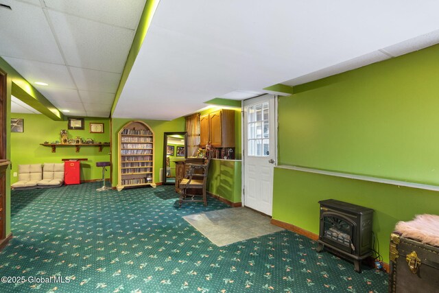 63 Pawling Ave, Mechanicville, NY 12118 - sitting room with baseboards, a wood stove, and carpet