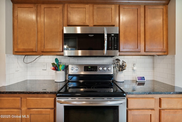 kitchen featuring backsplash, stainless steel appliances, and brown cabinets