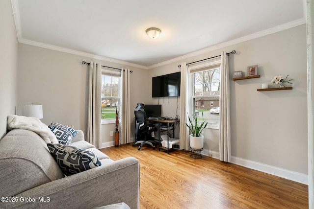 living room with baseboards, ornamental molding, and light wood-style floors
