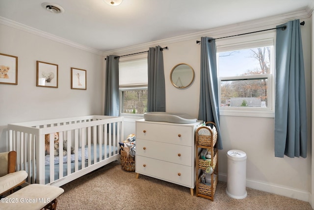 carpeted bedroom featuring crown molding, visible vents, multiple windows, and a crib