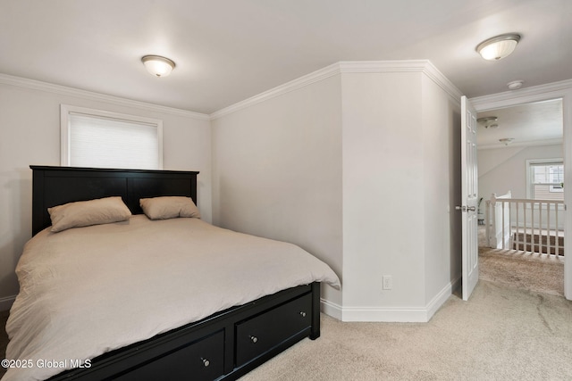 bedroom featuring crown molding, baseboards, and light carpet