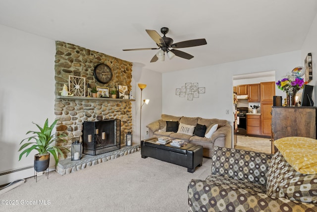 living room featuring a ceiling fan, a stone fireplace, and light colored carpet