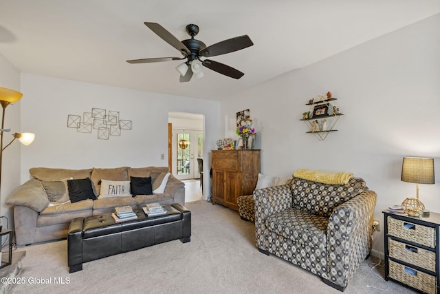 carpeted living area featuring ceiling fan