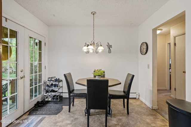 dining room with an inviting chandelier, a baseboard radiator, and a textured ceiling