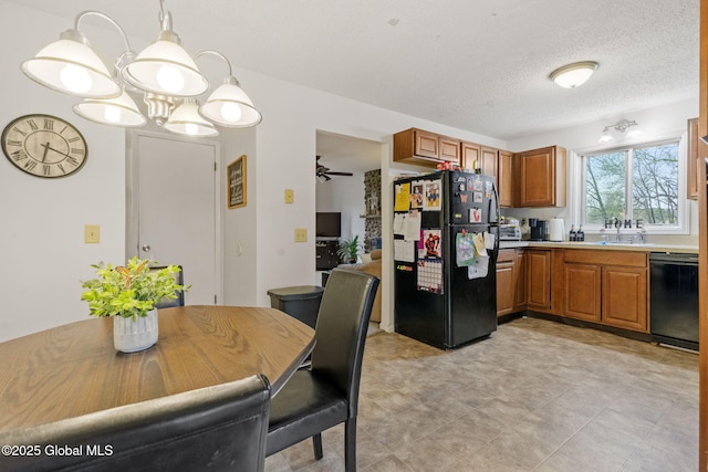 kitchen with light countertops, brown cabinets, a sink, black appliances, and decorative light fixtures